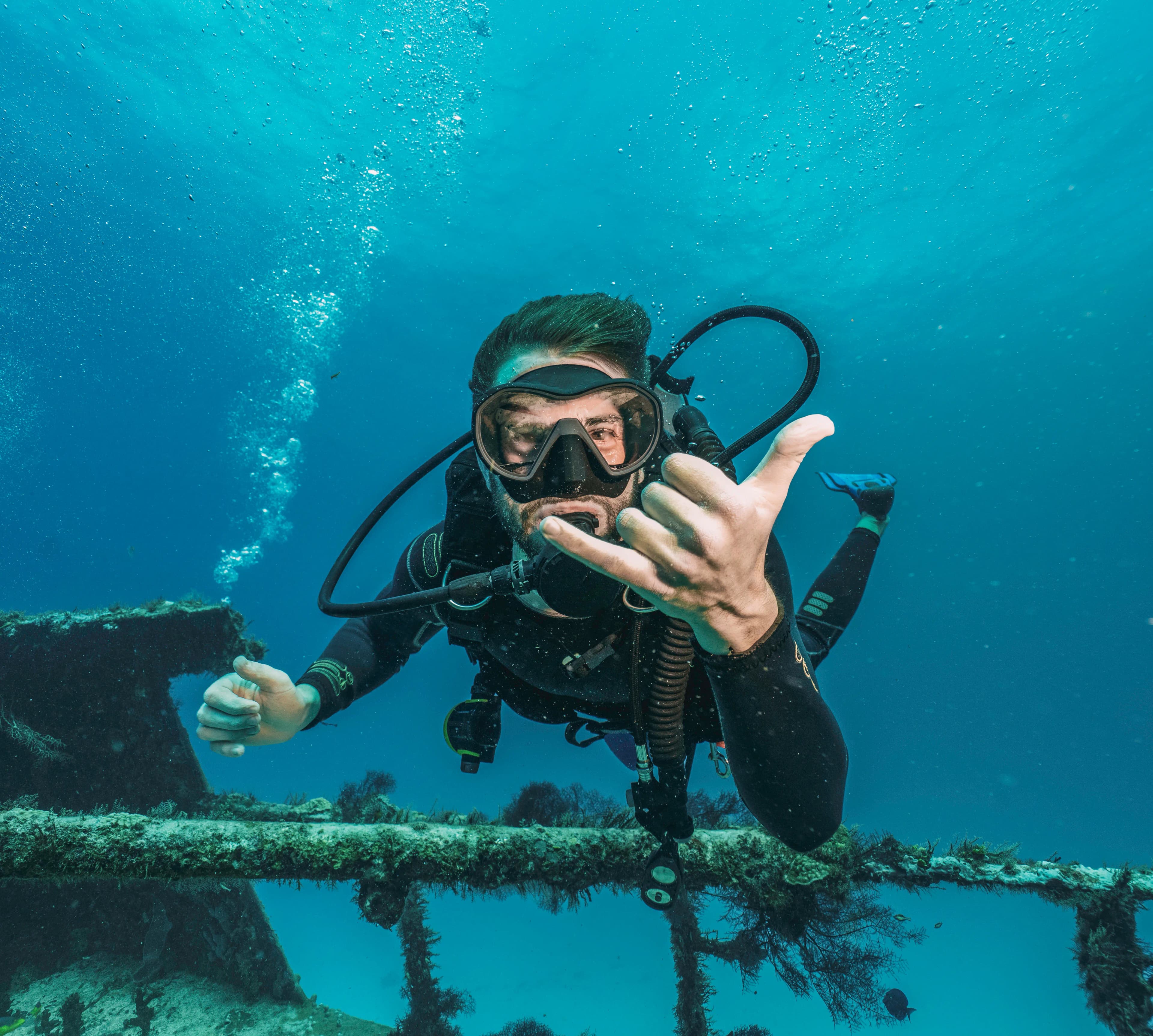 Professional scuba diver diving in a shipwreck