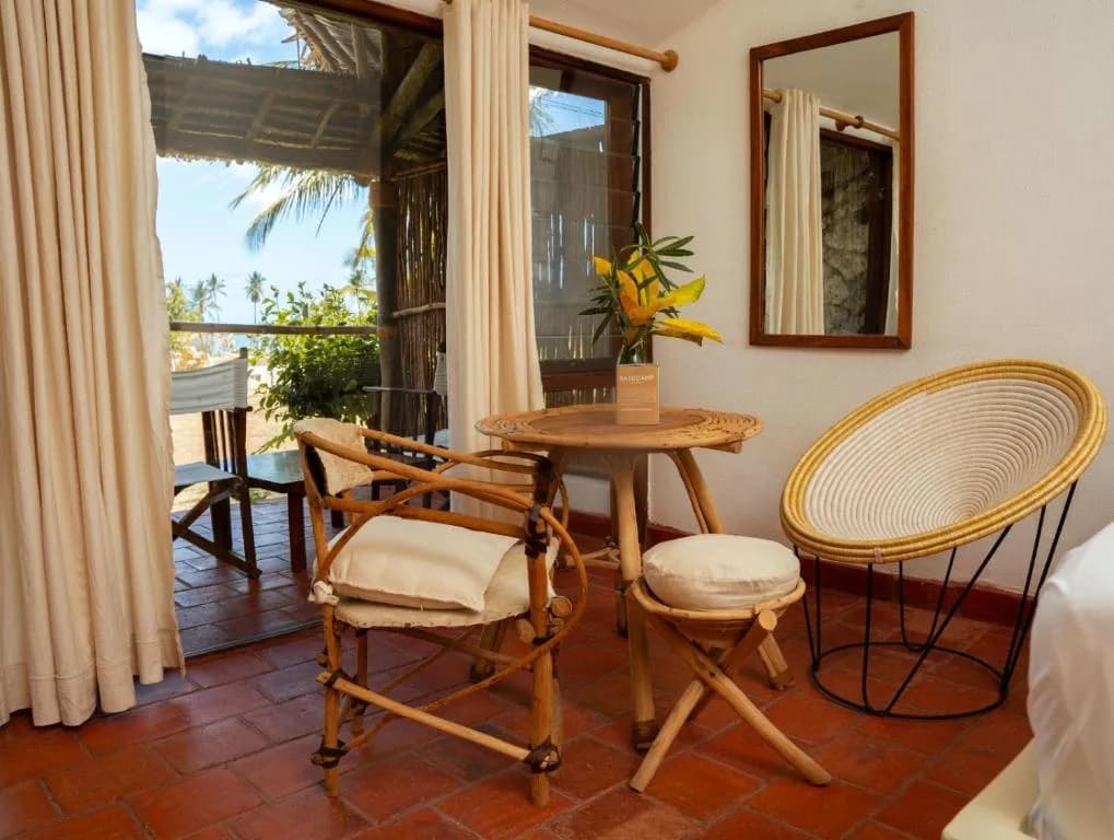 Room interior of the accommodation with rattan chairs and private balcony