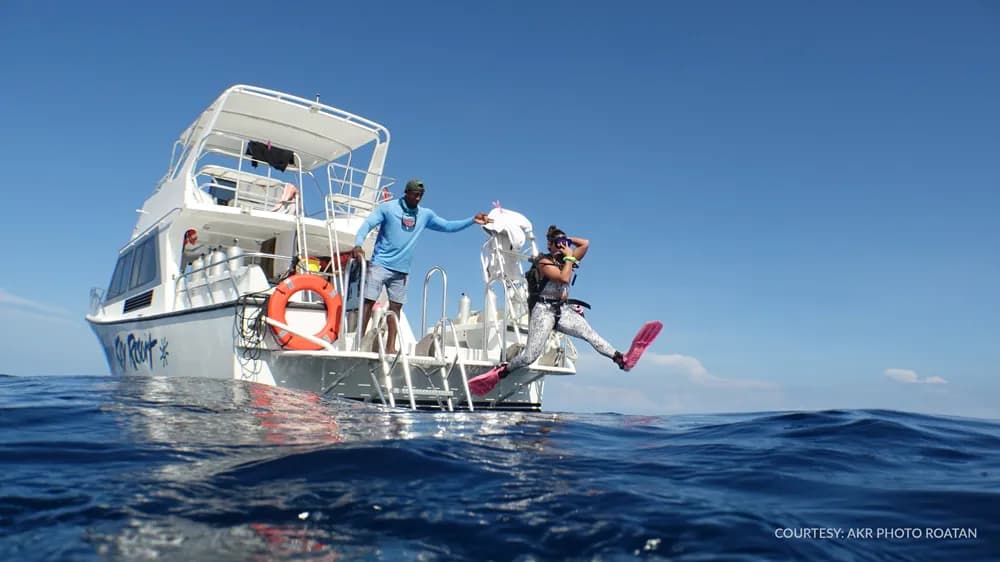 Divers entering water from boat