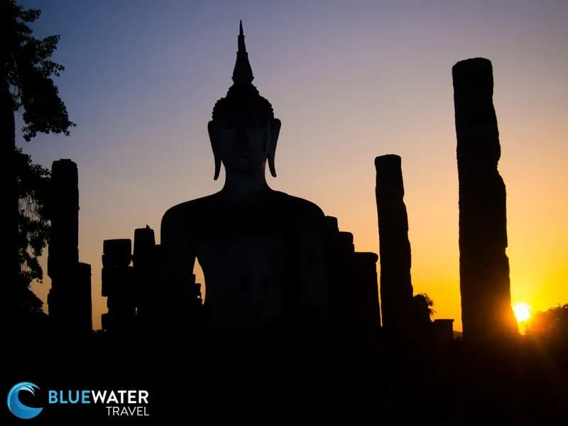 A silhouette of Buddha during a sunset in Thailand.