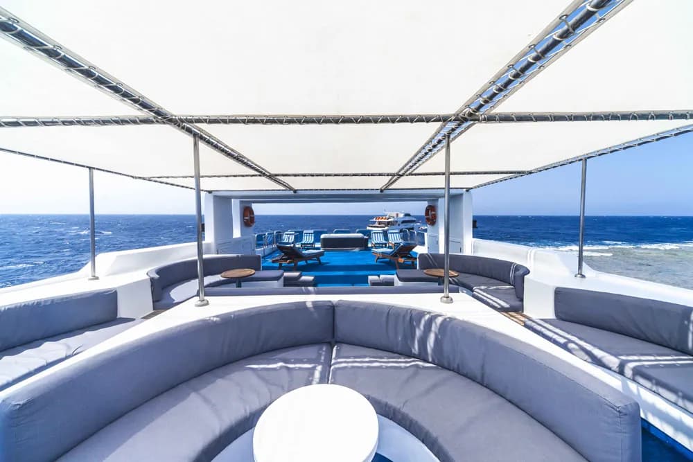 An outdoor seating area aboard the Royal Evolution liveaboard in the Red Sea.