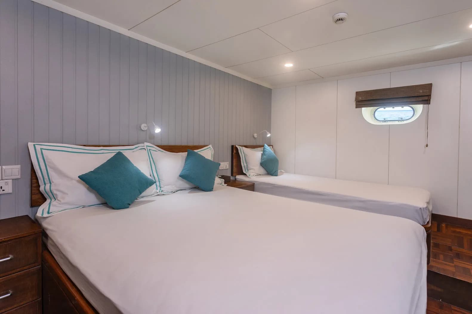 Standard cabin with two beds and a rectangular window