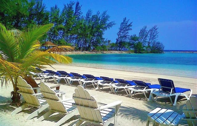 A row of beach chairs at Fantasy Island Roatan Resort.