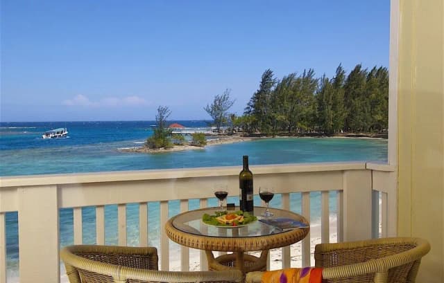 A balcony with an ocean view at Fantasy Island Roatan Resort.
