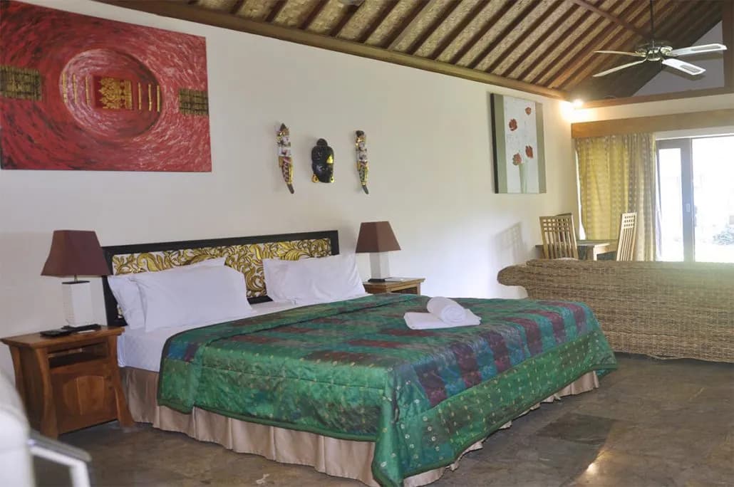 A bed in a double deluxe villa at Bayshore Villas Candidasa. A bed in a double deluxe villa at Bayshore Villas Candidasa.