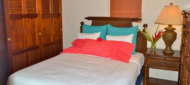 A bedroom in a master suite at Las Sirenas by Mayan Princess Roatan