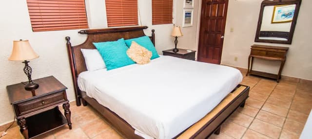 A bedroom in a two-bedroom family suite at Las Sirenas by Mayan Princess Roatan