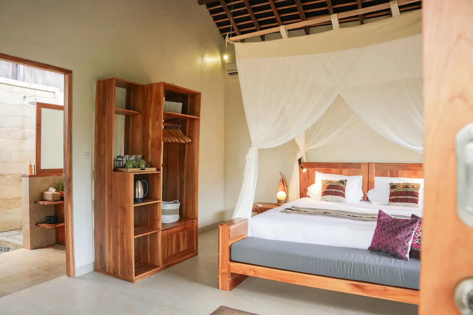 A tastefully decorated Hillside Bungalow with a large bed at Alor Tanapi Dive Resort.
