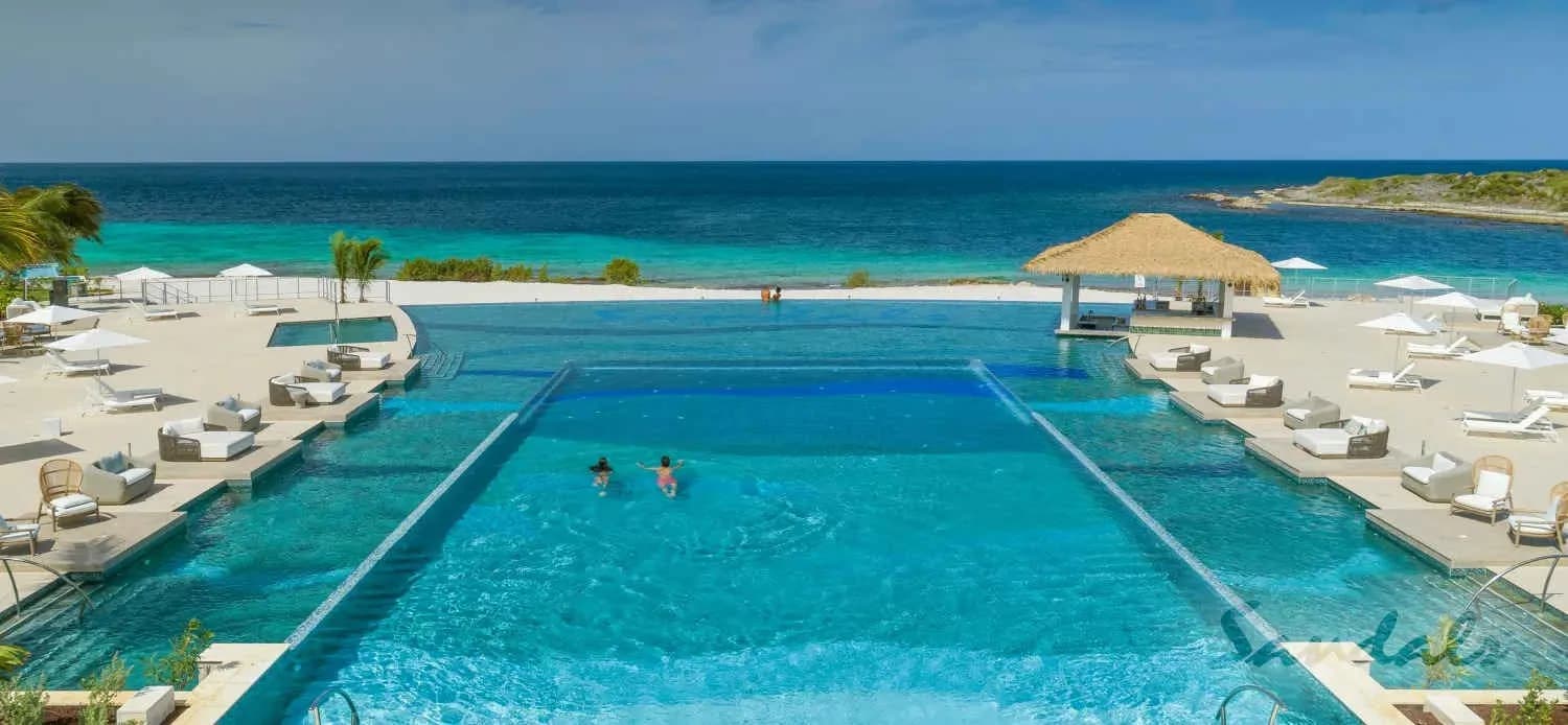 The Sandals pool with chairs alongside it The Sandals pool with chairs alongside it