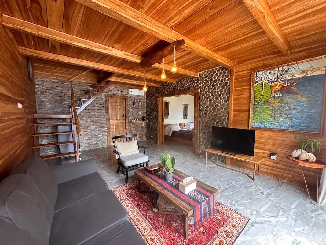 Downstairs living area with a couch and TV