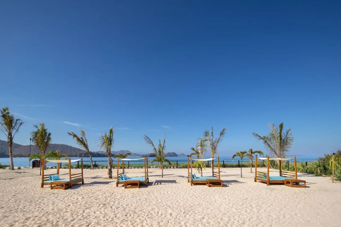 The beachfront with lounge areas and beds The beachfront with lounge areas and beds