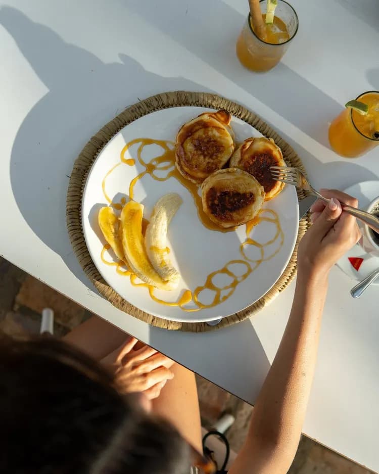 A guest eats a delicious breakfast served at HAPPI A guest eats a delicious breakfast served at HAPPI