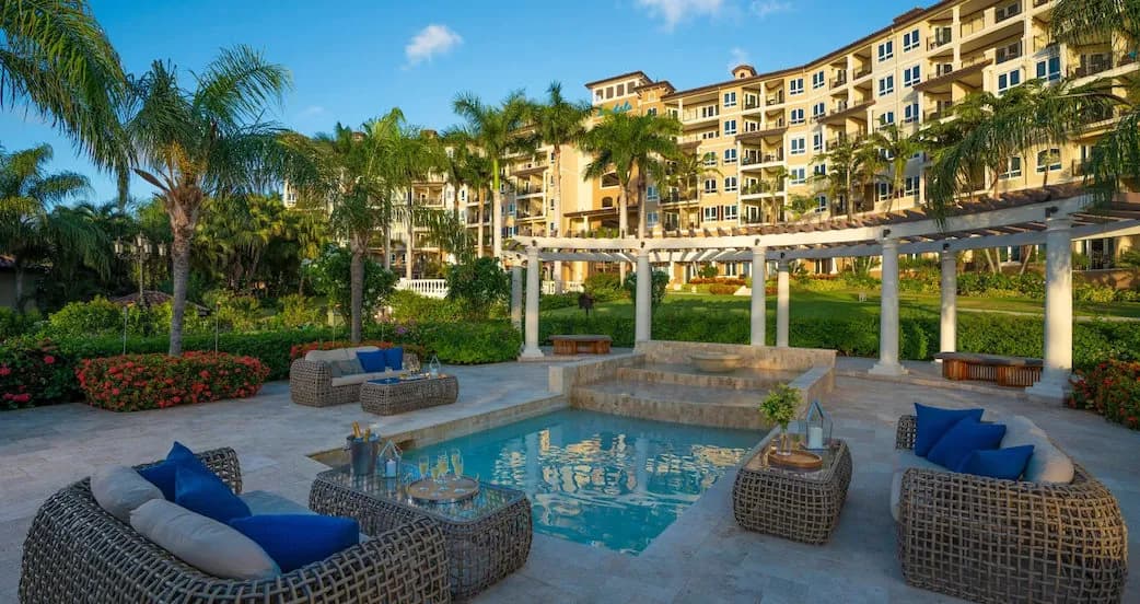 Relaxing couches set up around a small pool Relaxing couches set up around a small pool