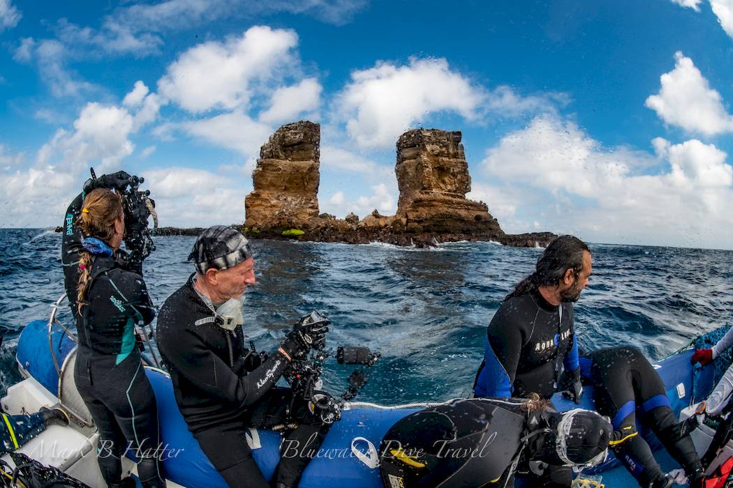 People on a dive boat in the Galapagos near Darwin's Rock.