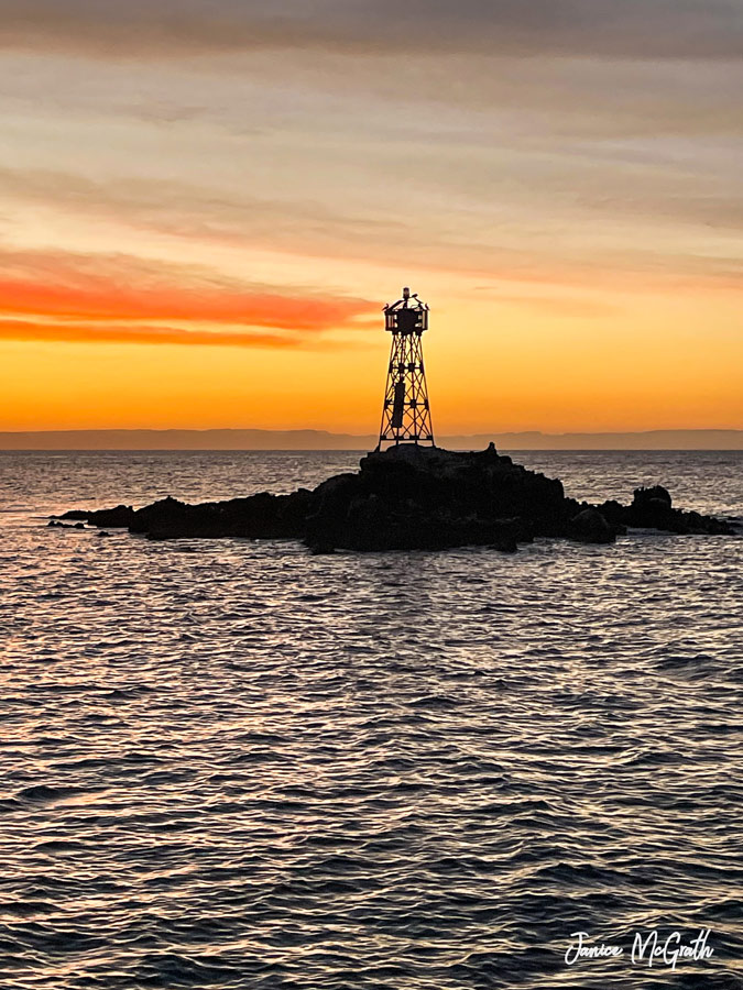 The sun sets over Lighthouse