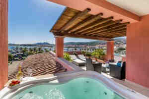 A terrace with a hot tub