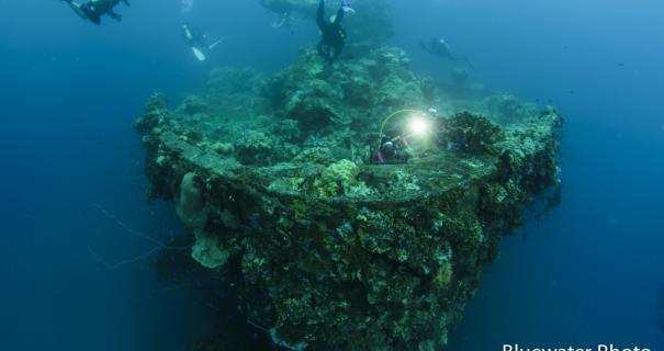 A shipwreck sits eerily underwater