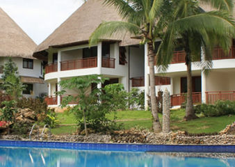 Building exteriors and a swimming pool at Amun Ini Beach Resort and Spa