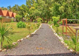 A gravel path with a walkway and trees