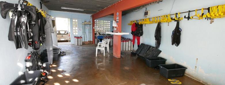 A room with scuba gear and a ladder, ready for underwater exploration.