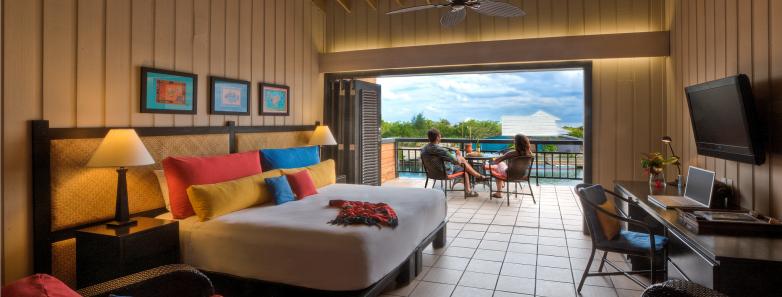 An oceanview room with bed and sitting area Barefoot Caye Roatan