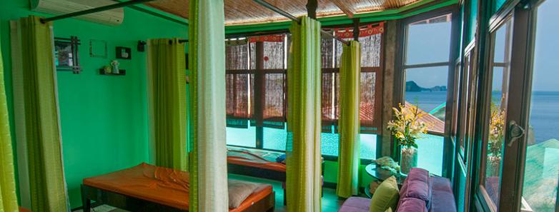 Vibrant spa room with colorful furniture and ocean view at Crystal Blue Resort in Anilao, Philippines.