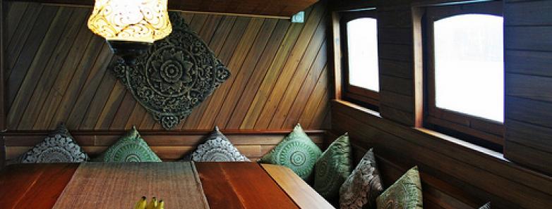 A dining table with benches aboard the Diva Andaman Liveaboard