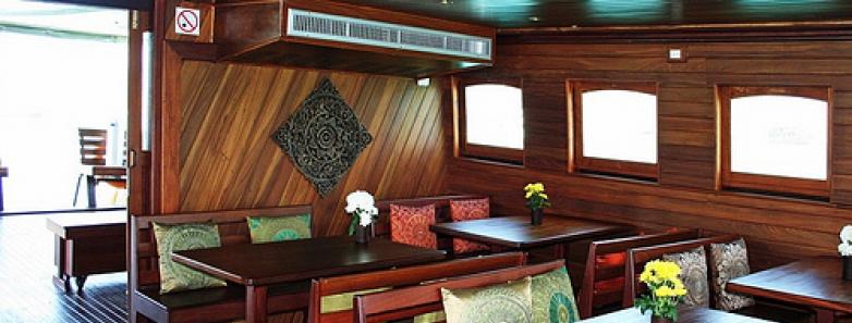 Dining tables and chairs aboard the Diva Andaman Liveaboard