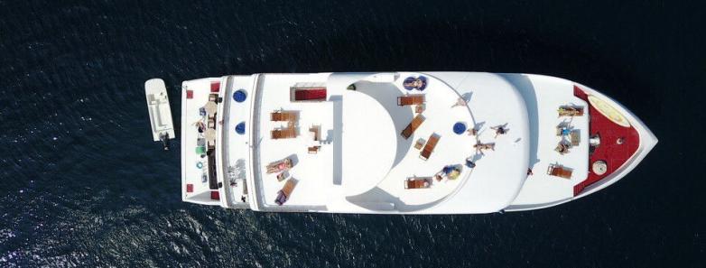MV Emperor Serenity Liveaboard in the Maldives: a luxurious boat sailing in crystal-clear waters.