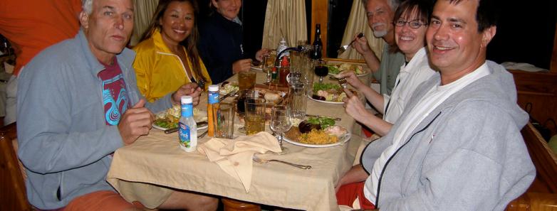 A group eating dinner aboard the Galapagos Aggressor III Liveaboard