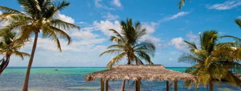 A beach cabana with hammocks at Little Cayman Beach Resort