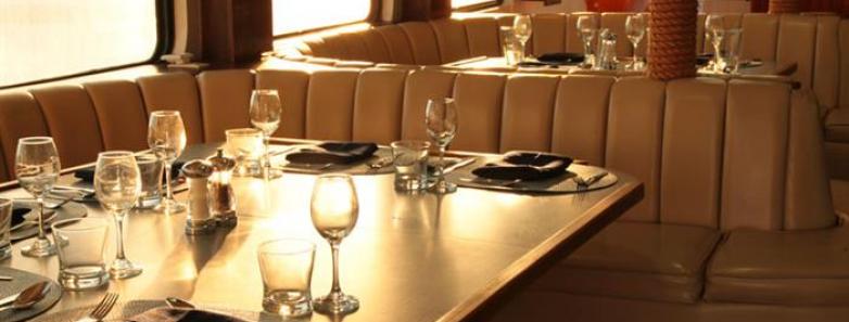 Dining tables set for dinner aboard the MV Valentina liveaboard.
