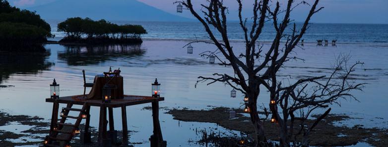 A table is set for a romantic beach dinner at Plataran Menjangan Resort & Spa Bali