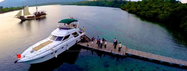 A small yacht and a phisini at the Plataran Menjangan Resort & Spa Bali jetty