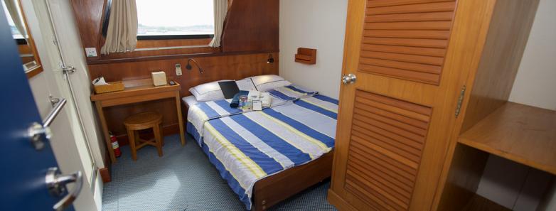 A cabin interior with a double bed