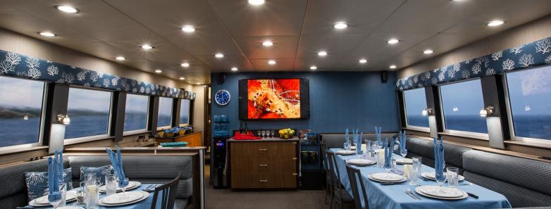The modern dining room aboard the Roatan Aggressor Liveaboard.