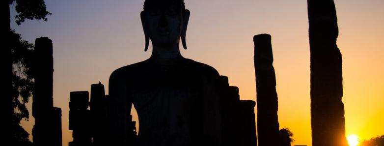 A silhouette of Buddha during a sunset in Thailand.