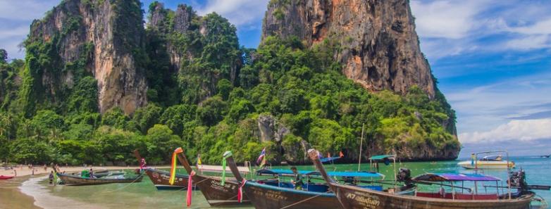 Wooden boats and limestone karsts at Railay Beach in Thailand.