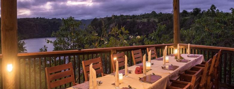 A long table is set for dinner at dusk at Tufi Resort Papua New Guinea