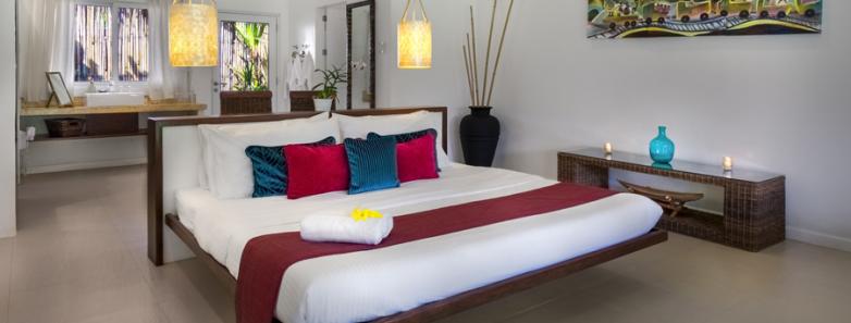 A bed in a deluxe suite at Atmosphere Resort.