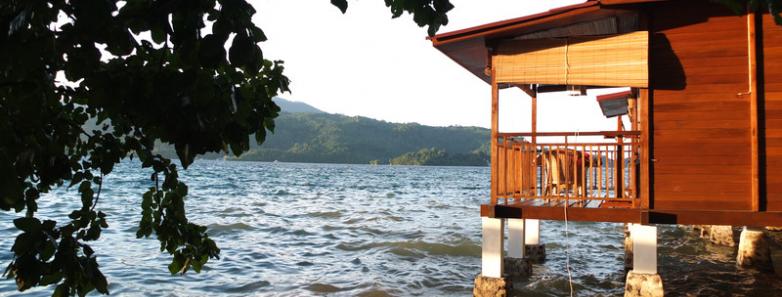 A small building sits over the ocean at Bastianos Dive Resort Lembeh