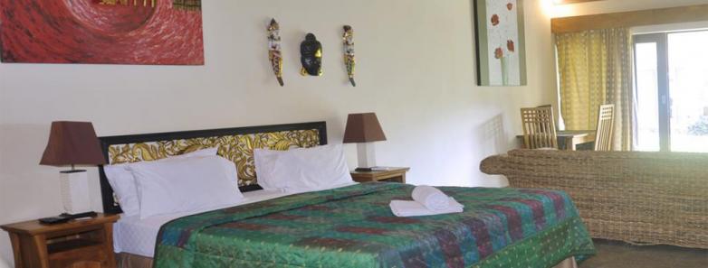 A bed in a double deluxe villa at Bayshore Villas Candidasa.