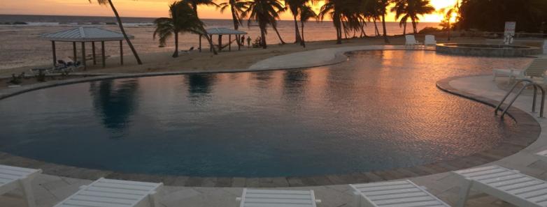 A sunset view of the pool at Cayman Brac Beach Resort