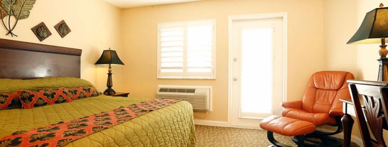 Interior of a room with a king bed at Cayman Brac Beach Resort