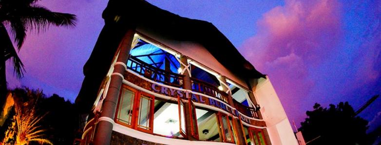 Crystal Blue Resort in Anilao, Philippines: A stunning hotel building nestled amidst breathtaking surroundings.