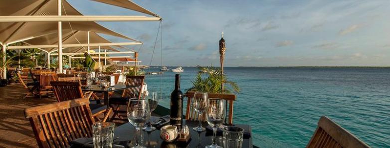 Outdoor seaside dining area at Captain Don's Habitat dive resort in Bonaire