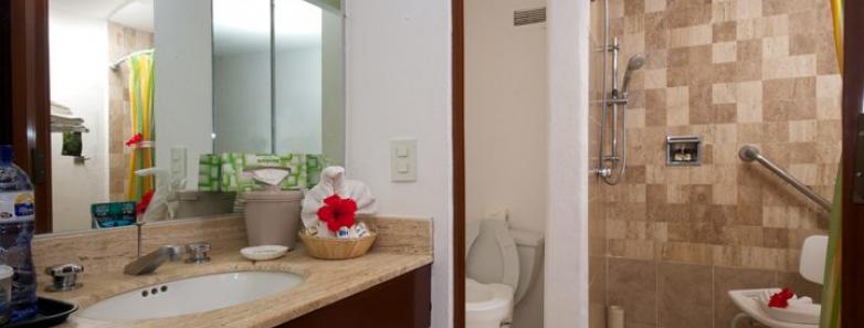 A modern bathroom with a shower and toilet at Cozumel Palace hotel in Mexico.