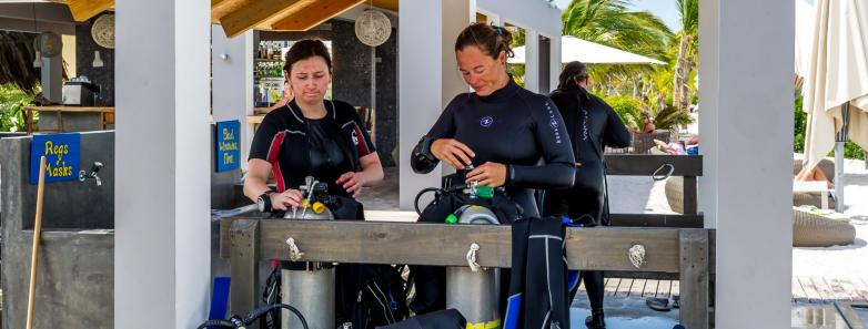 Scuba divers set up their equipment at Delfins Beach Resort Bonaire.