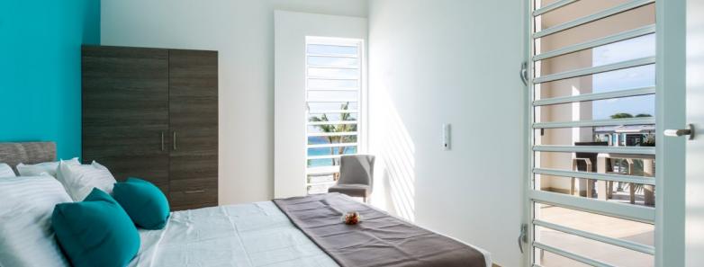 The modern bedroom in a 1 bedroom apartment at Delfins Beach Resort Bonaire.