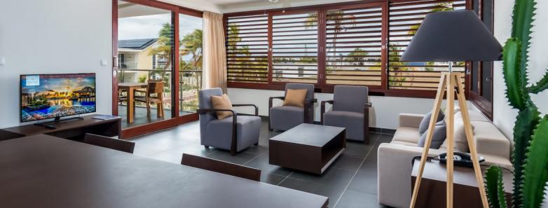 A modern living room in a 2 bedroom apartment at Delfins Beach Resort Bonaire.